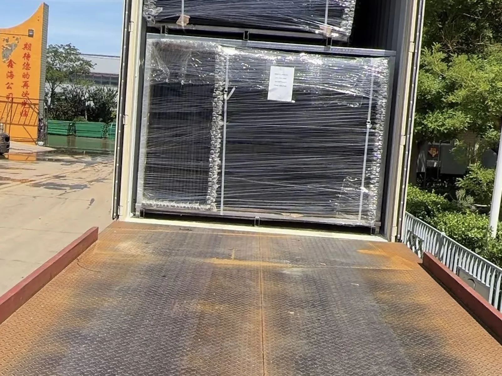 Protected fence panel bundles positioned for container loading