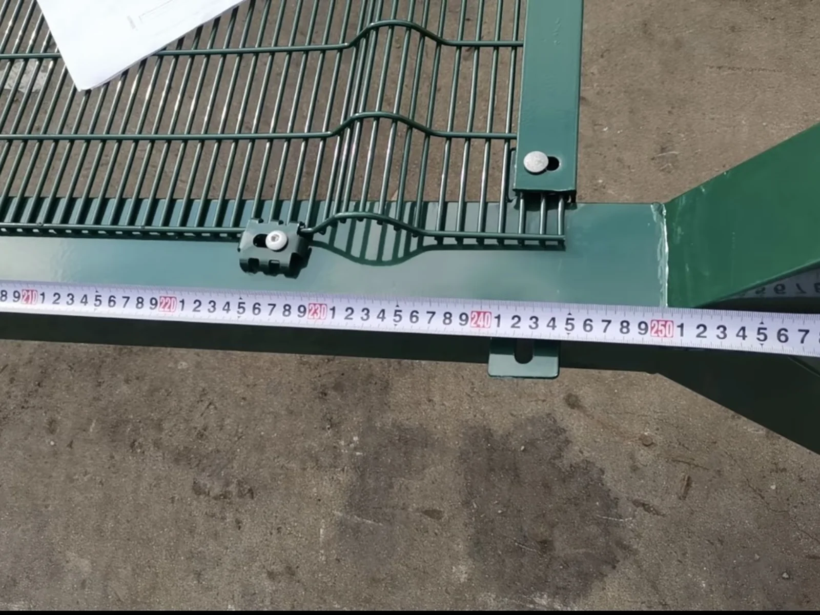 Tape measurement across a welded mesh fence panel and reinforcement fold