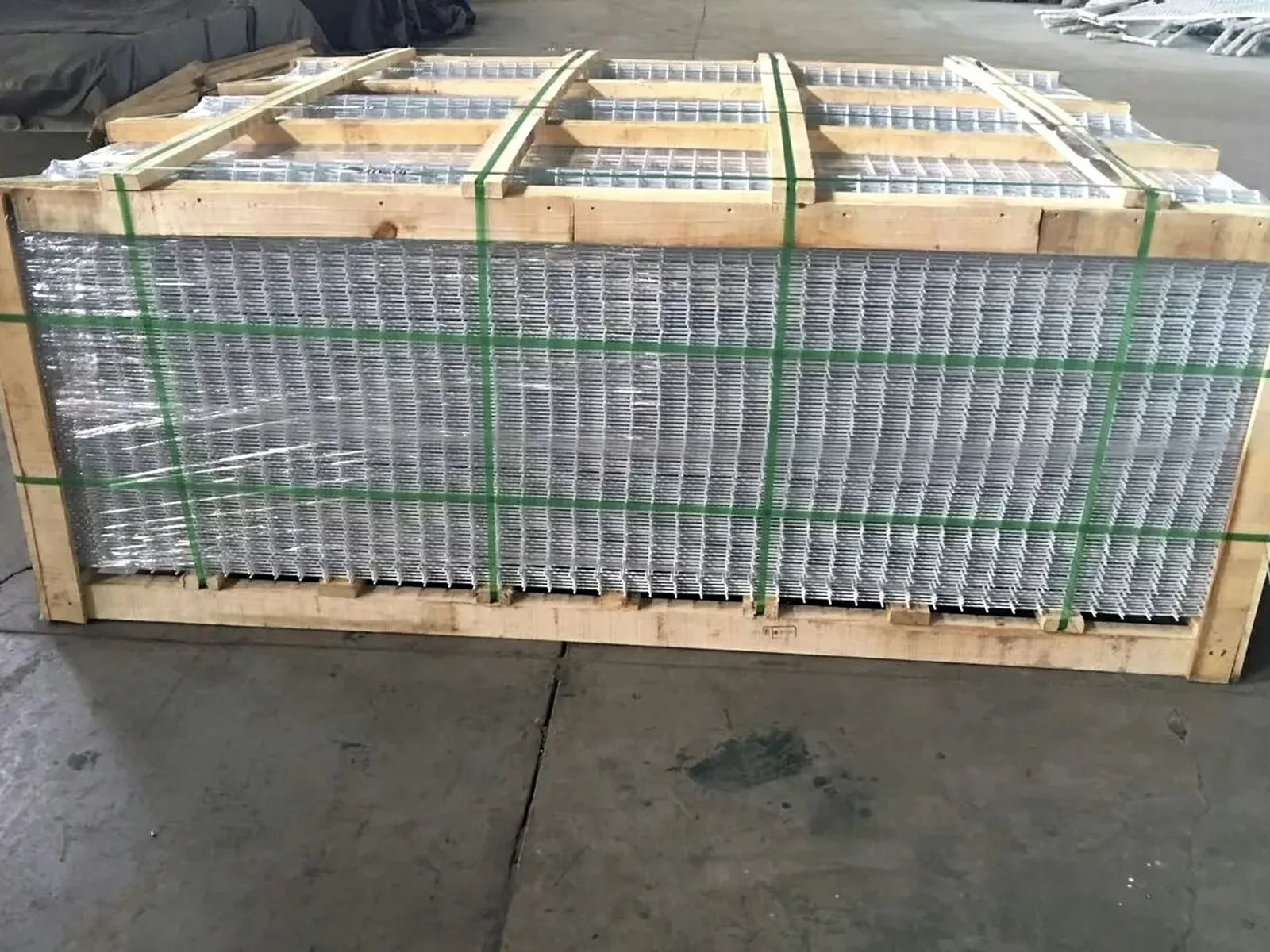 Galvanized welded mesh fence panels strapped in a protected export bundle